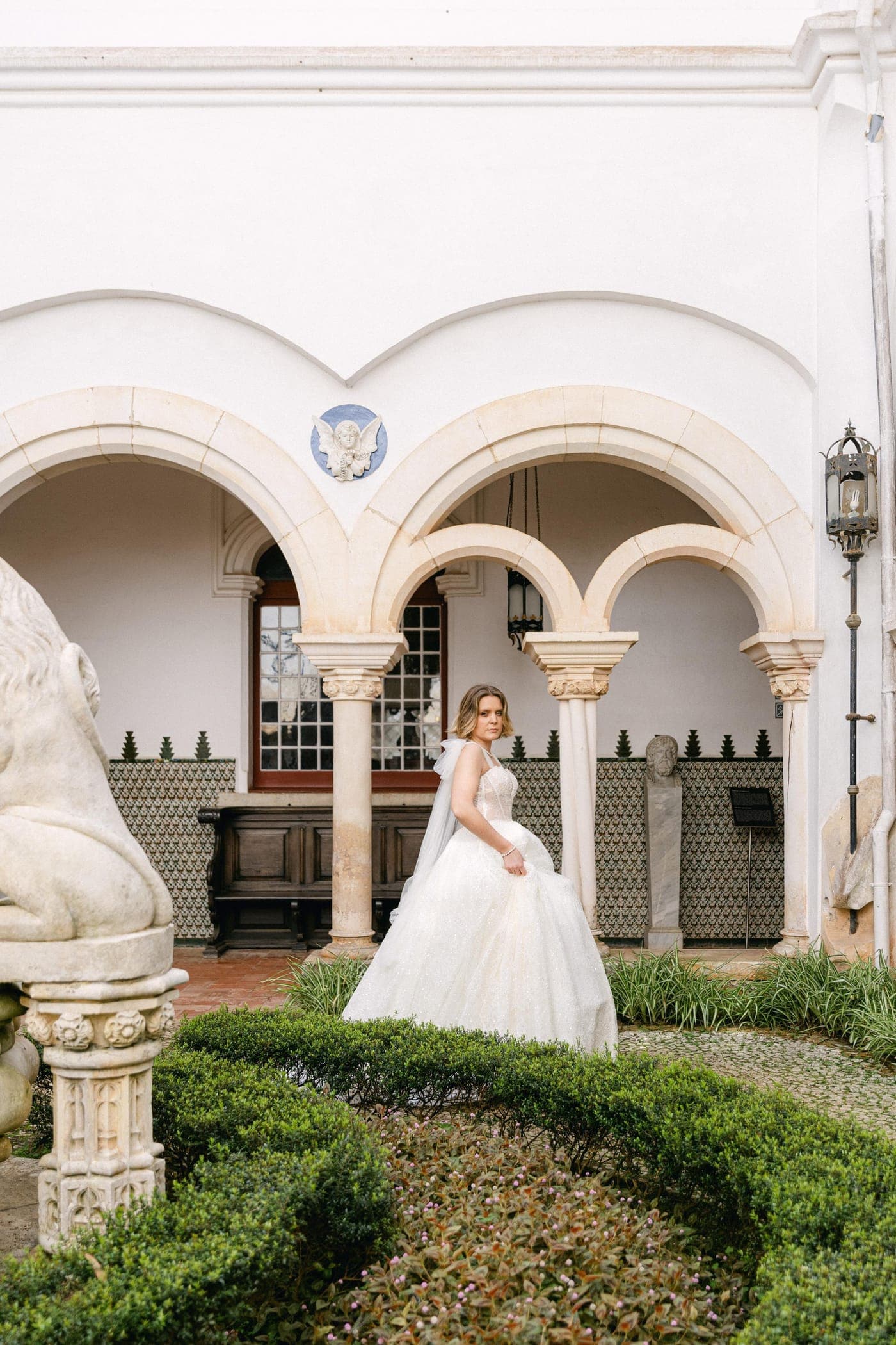 Full length beneath the arches and topiary