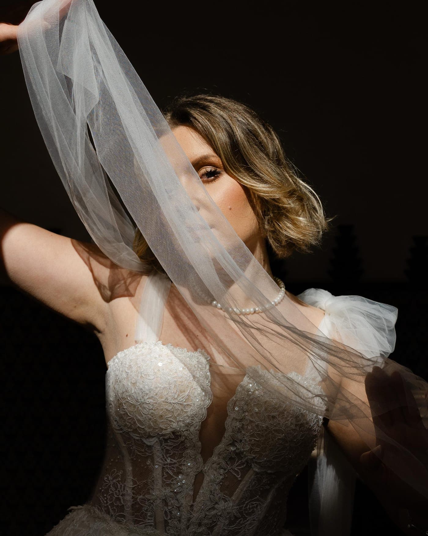 Veil held against a dark ground