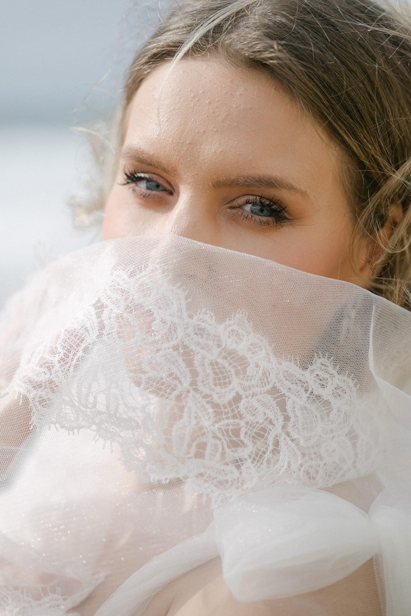 Lace veil drawn across the face