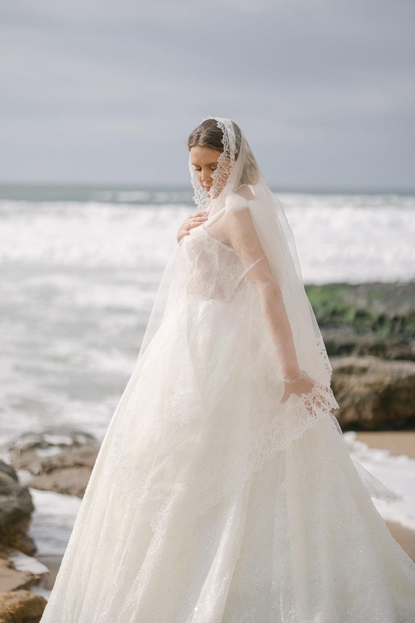 Standing on the rocks, veil to the wind