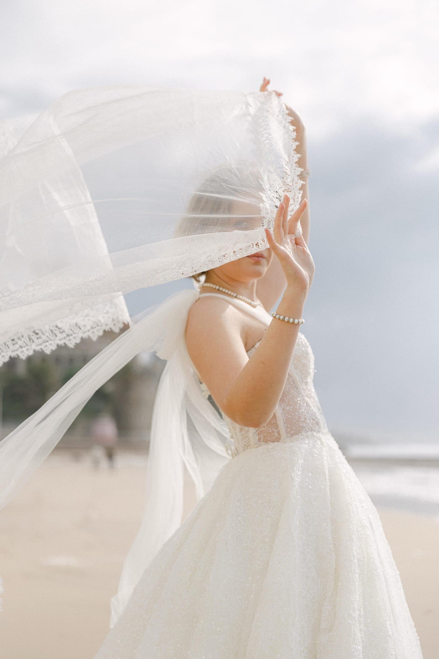 Portrait behind lace, sea in the distance