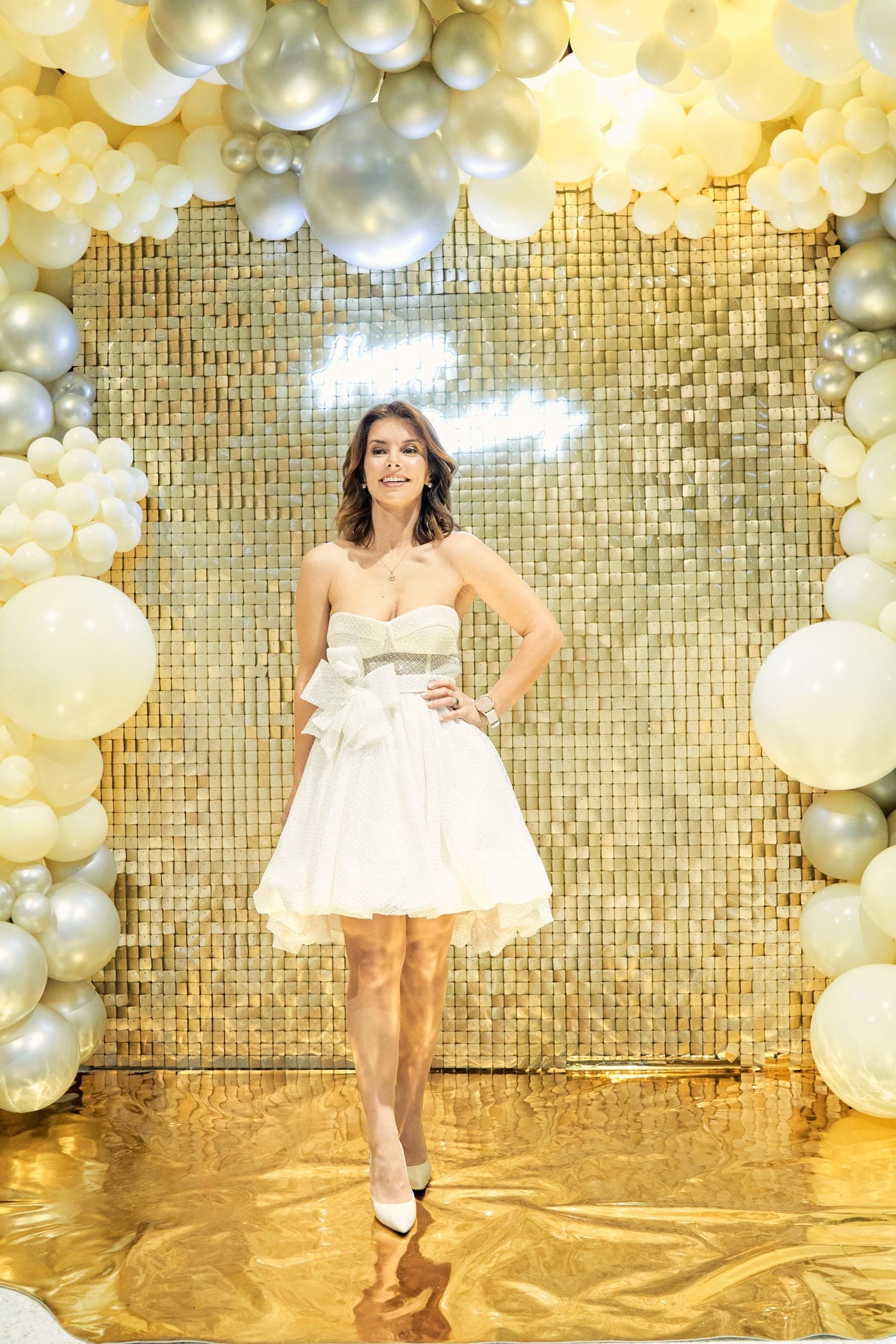 Against the gold sequin wall