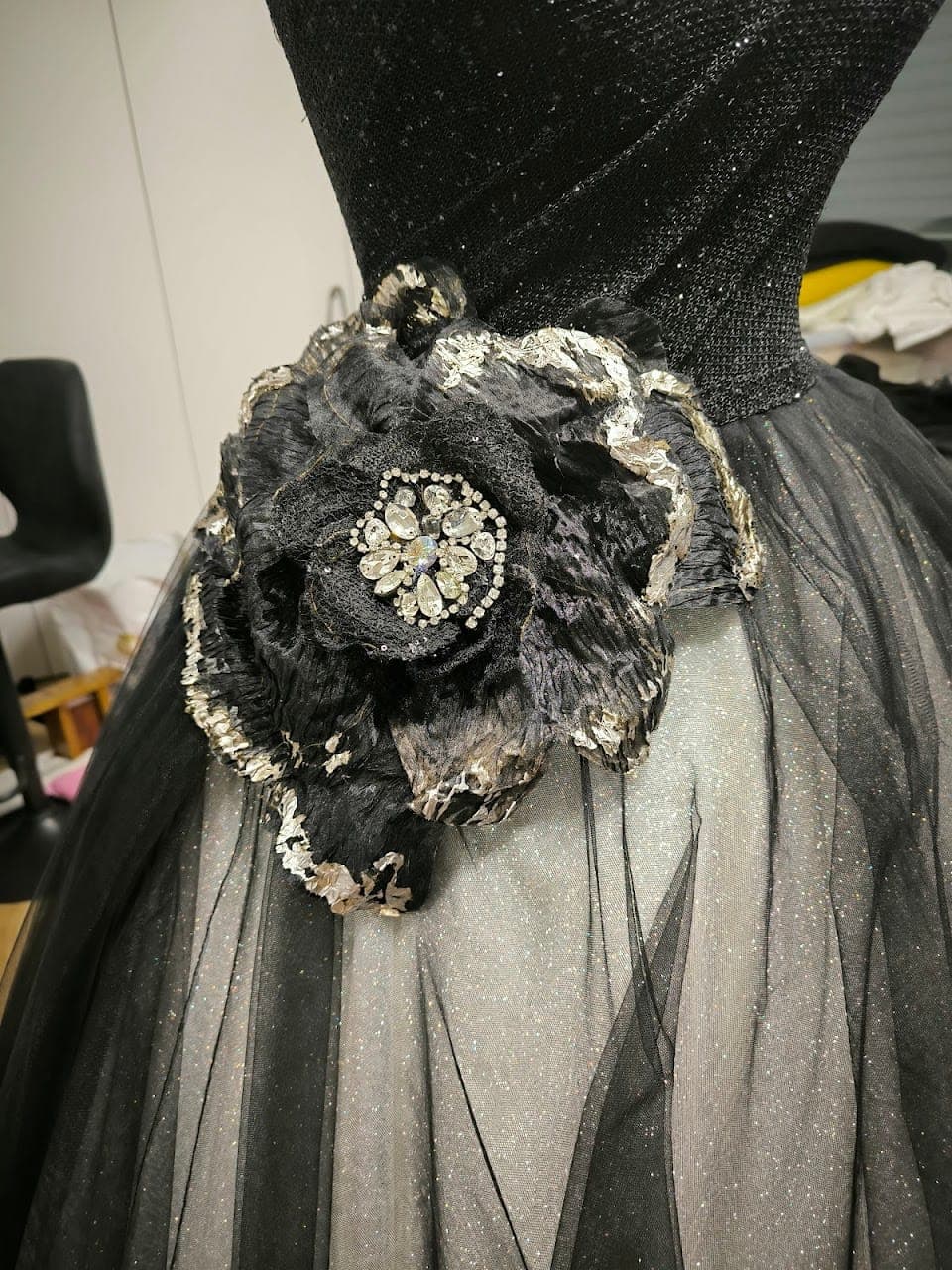 Beading and brooch at the flower's centre