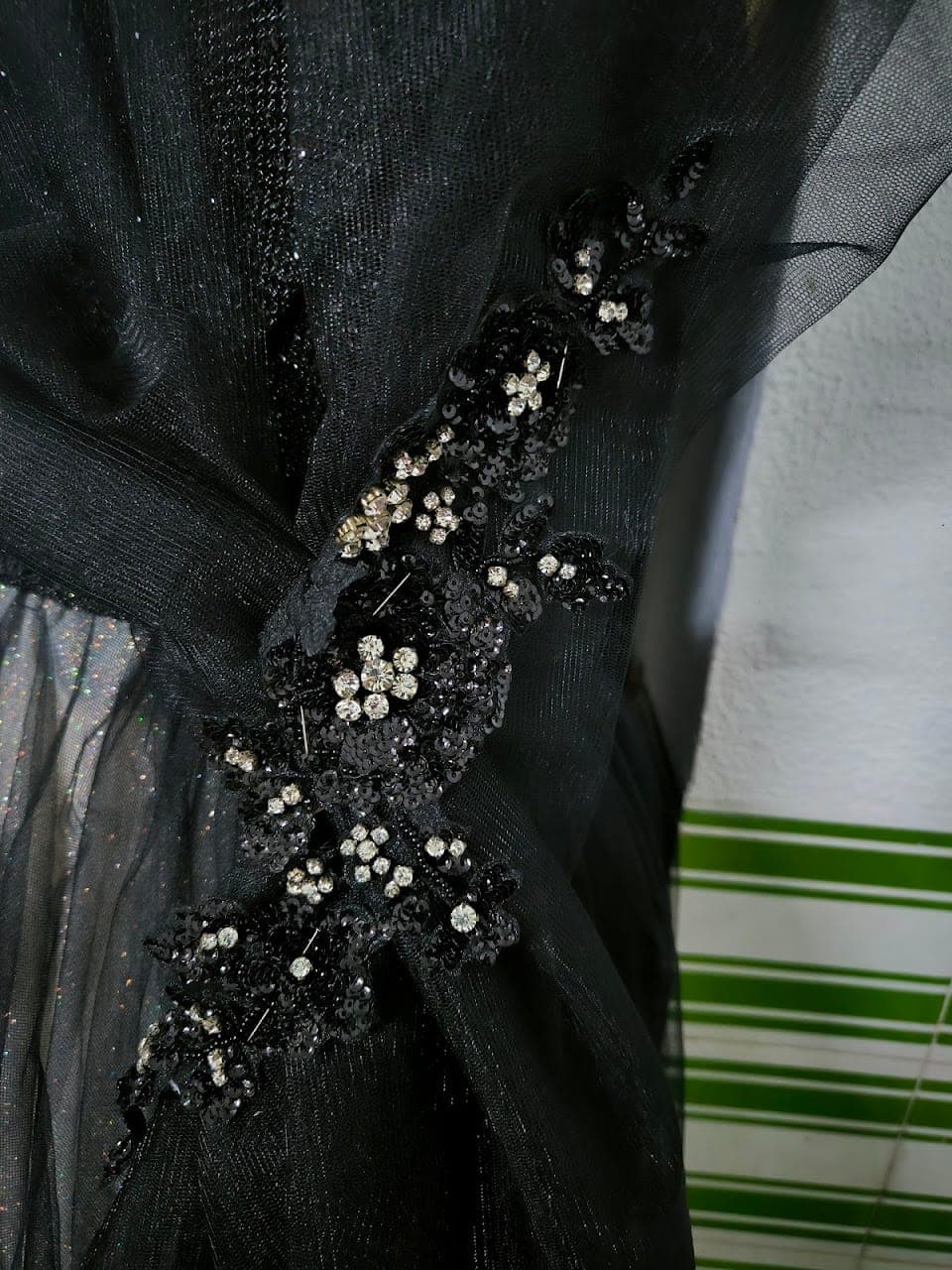 Hand-beaded detail across the tulle