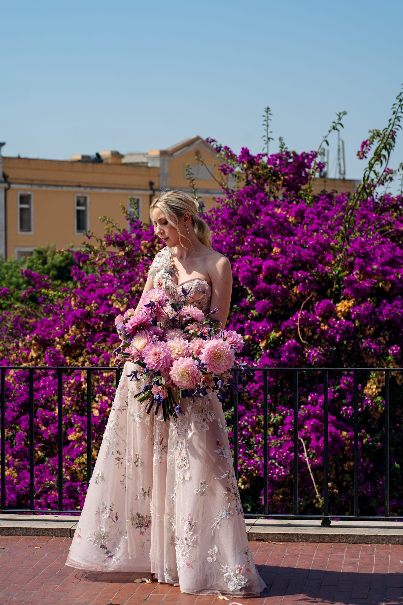 Standing in full sun, bouquet held low