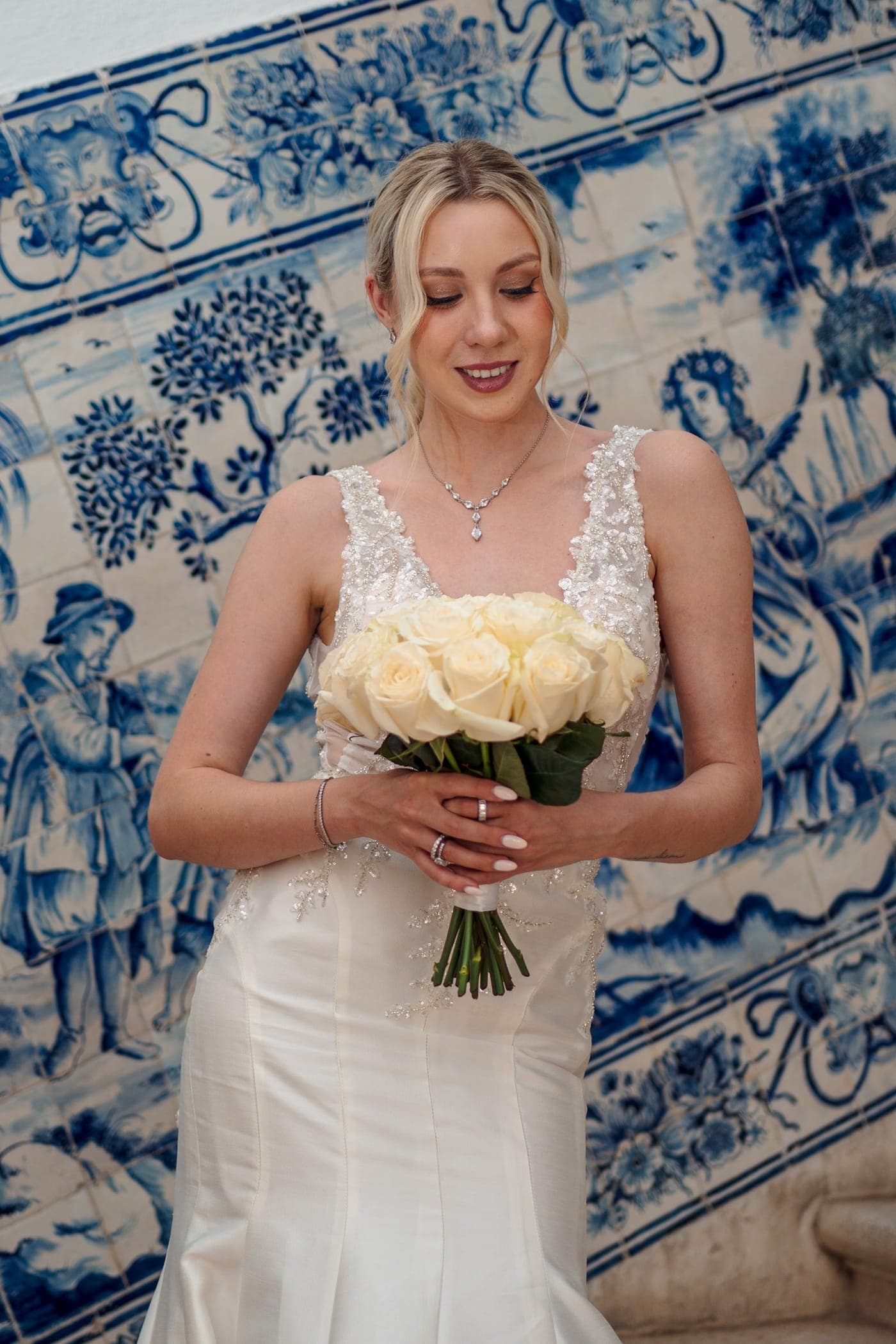Bouquet held low, tile behind